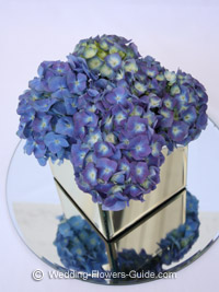 blue hydrangea wedding flowers in a cube mirror vase